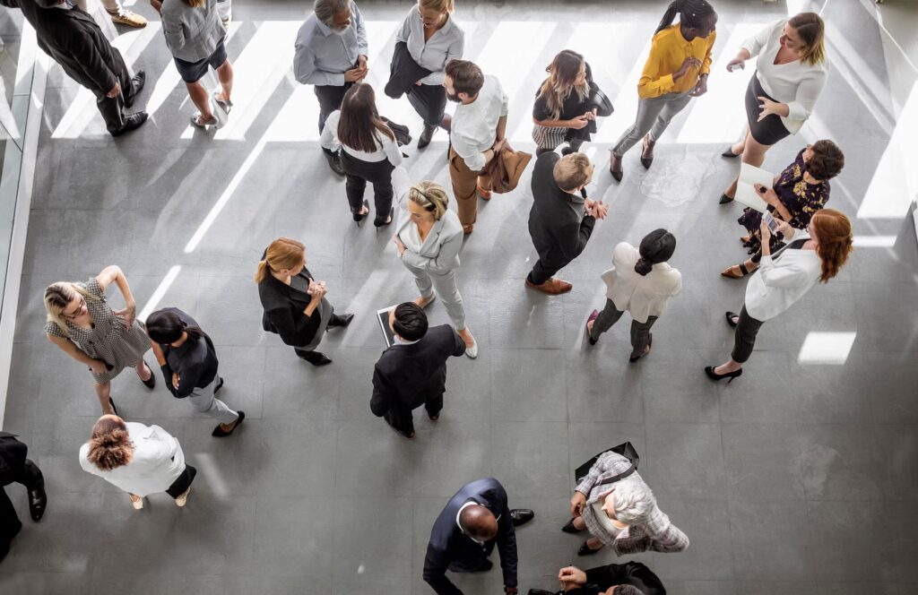 Business people meeting and networking in an office lobby, seen from above
