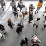 Business people meeting and networking in an office lobby, seen from above